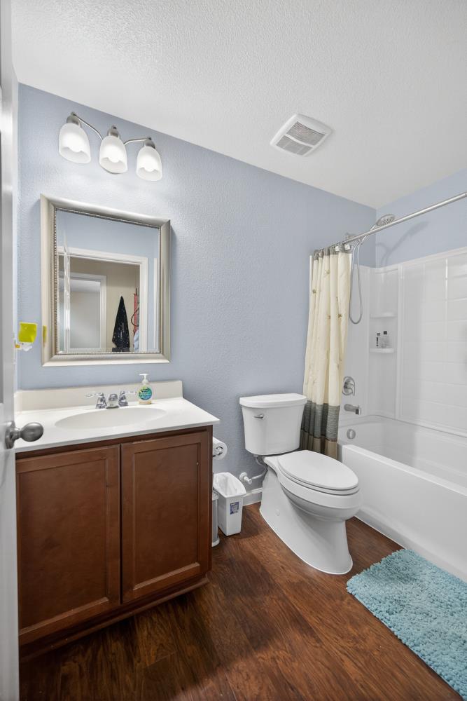 7467 Garden Ridge Way Sacramento, CA 95829 - Photo 17 of 54 a bathroom with a sink toilet a mirror and bathtub