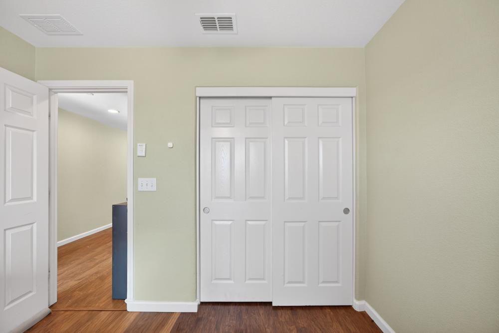 7467 Garden Ridge Way Sacramento, CA 95829 - Photo 19 of 54 an empty room with wooden floor and closet