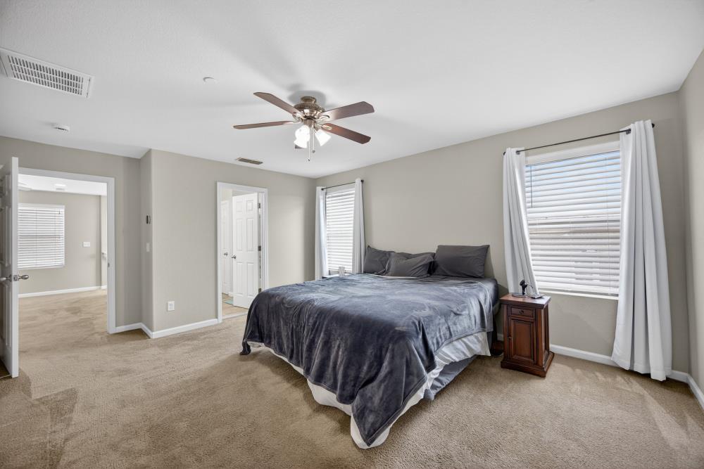 7467 Garden Ridge Way Sacramento, CA 95829 - Photo 24 of 54 a spacious bedroom with a bed and a window