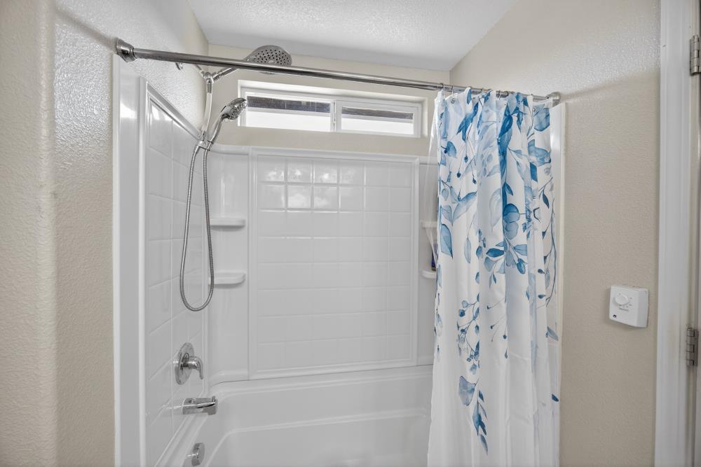 7467 Garden Ridge Way Sacramento, CA 95829 - Photo 27 of 54 a bathroom with a glass shower door