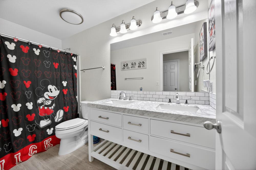 7467 Garden Ridge Way Sacramento, CA 95829 - Photo 35 of 54 a bathroom with a sink vanity mirror and toilet