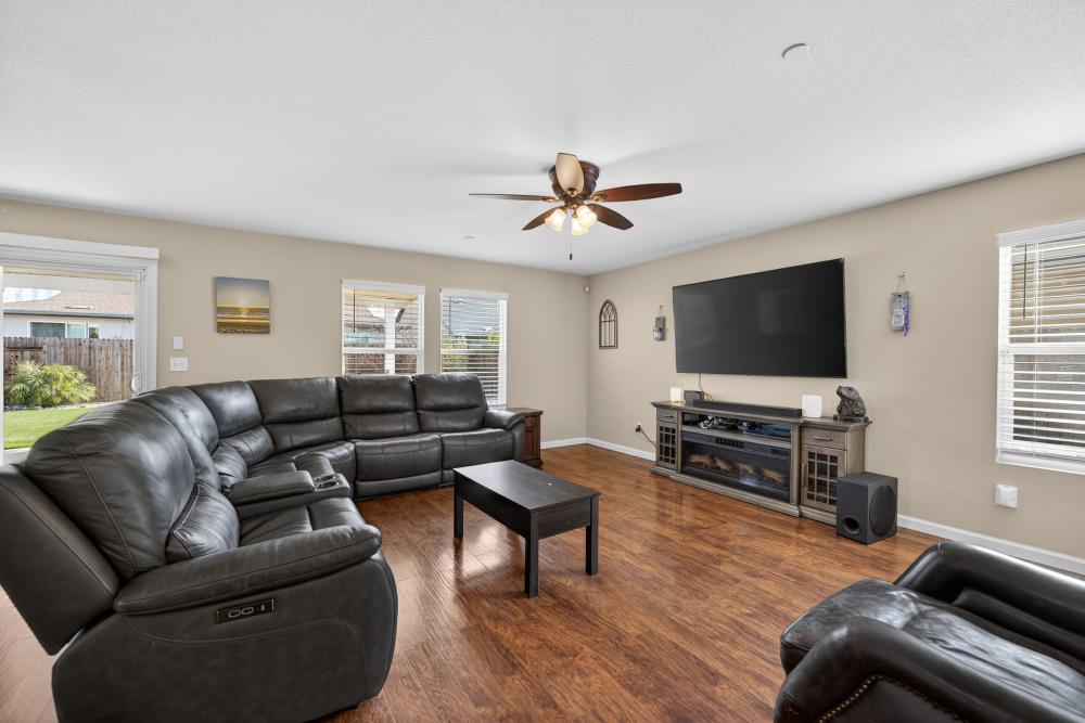 7467 Garden Ridge Way Sacramento, CA 95829 - Photo 7 of 54 a living room with furniture and a flat screen tv