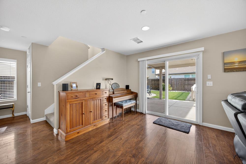 7467 Garden Ridge Way Sacramento, CA 95829 - Photo 9 of 54 a living room with furniture and a wooden floor