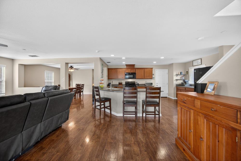7467 Garden Ridge Way Sacramento, CA 95829 - Photo 10 of 54 a living room with furniture and kitchen view with wooden floor