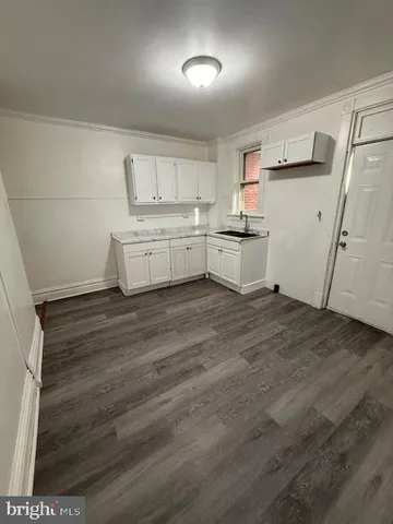 a kitchen with white cabinets and white appliances