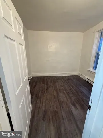 a view of a room with wooden floor and staircase