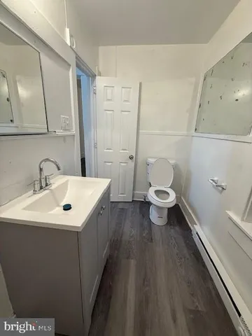 a bathroom with a sink a toilet and a mirror