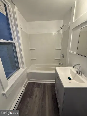 a bathroom with a sink a mirror and a shower