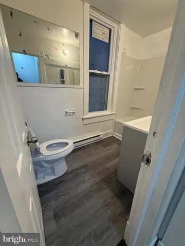 a bathroom with a toilet and a shower