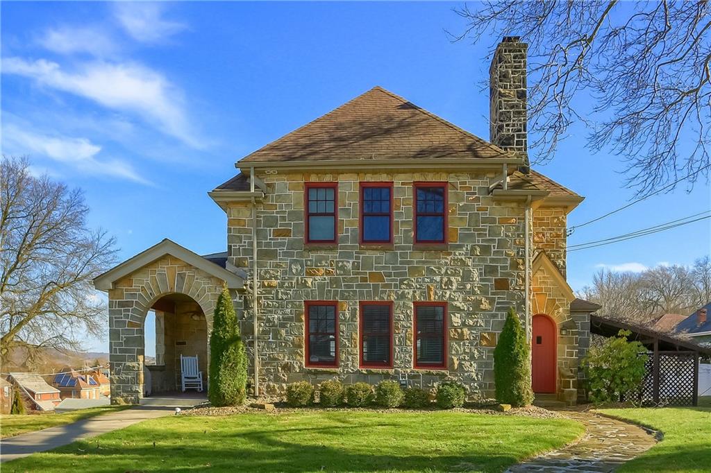 a front view of a house with a garden