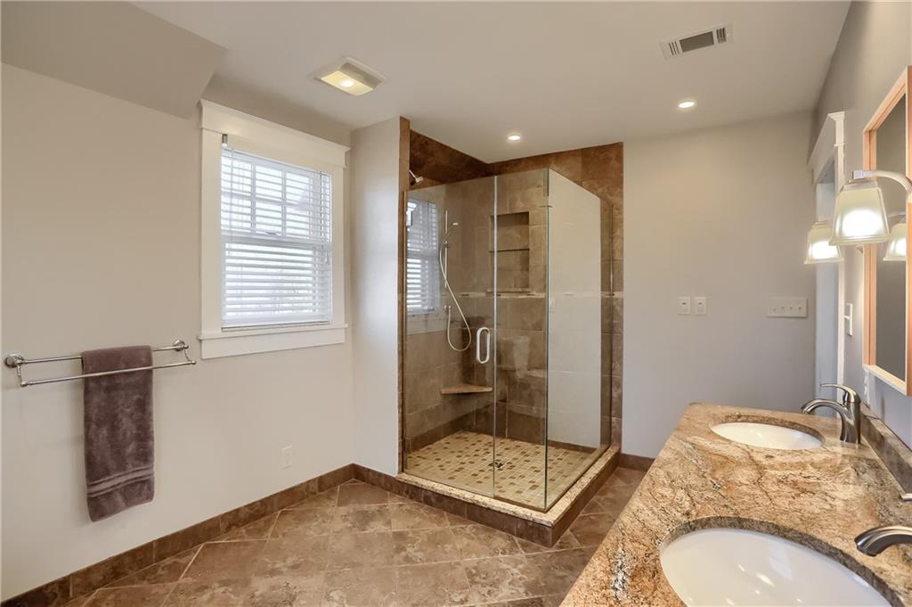 801 Main Street Coraopolis, PA 15108 - Photo 15 of 25 a bathroom with a granite countertop sink a mirror and a shower