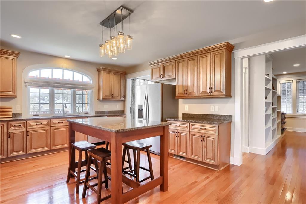 801 Main Street Coraopolis, PA 15108 - Photo 5 of 25 a kitchen with stainless steel appliances granite countertop wooden floors and white cabinets