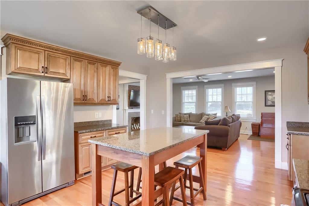 801 Main Street Coraopolis, PA 15108 - Photo 7 of 25 a kitchen with stainless steel appliances granite countertop a dining table chairs refrigerator and cabinets