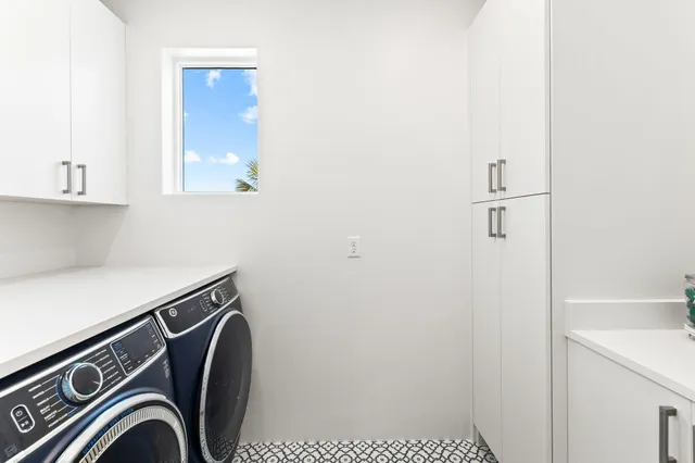 a bedroom with furniture and large windows