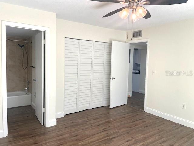 4800 Rilma Avenue, Unit 141 Sarasota, FL 34234 - Photo 12 of 19 an empty room with wooden floor and ceiling fan