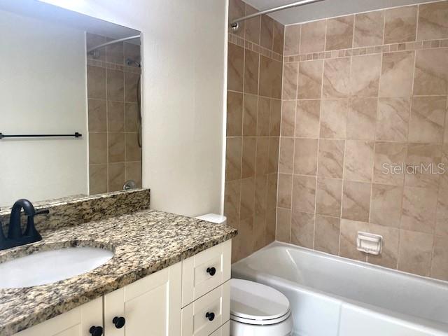 4800 Rilma Avenue, Unit 141 Sarasota, FL 34234 - Photo 13 of 19 a bathroom with a granite countertop sink toilet and shower