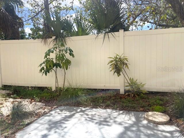 4800 Rilma Avenue, Unit 141 Sarasota, FL 34234 - Photo 14 of 19 a palm tree sitting in front of a white house