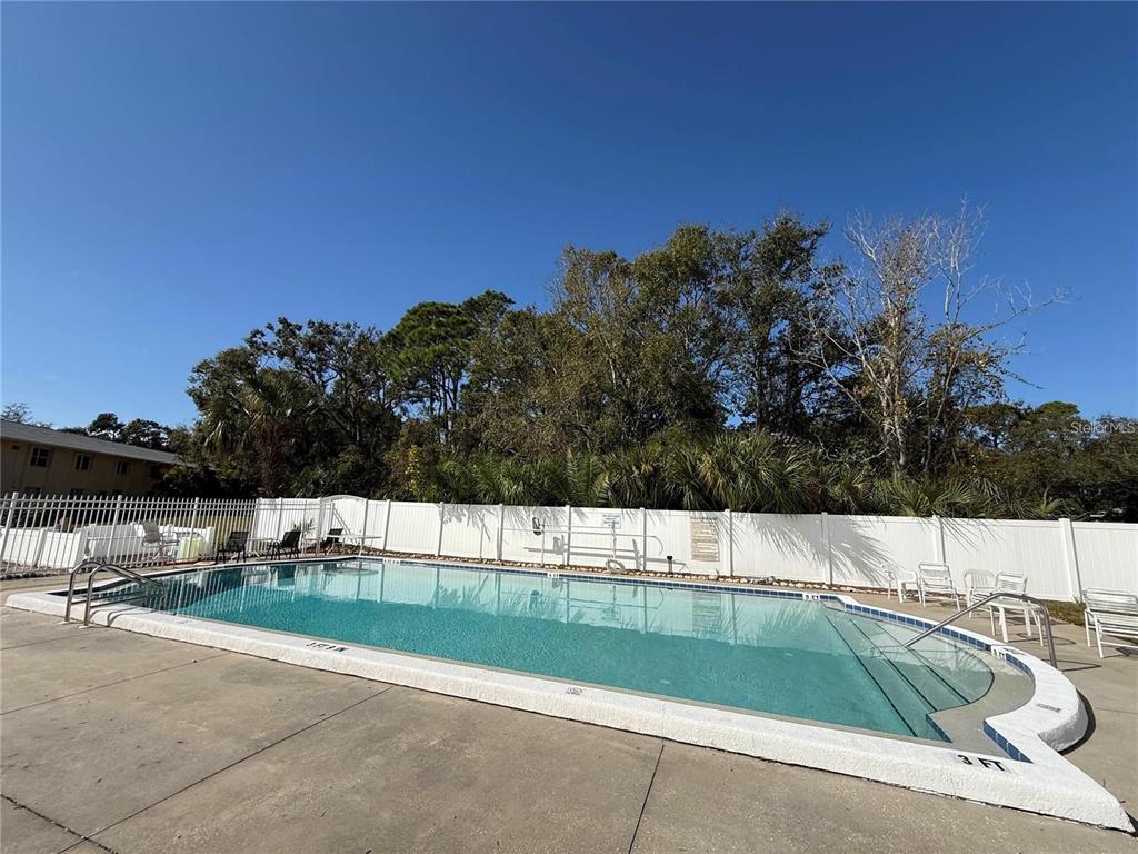 4800 Rilma Avenue, Unit 141 Sarasota, FL 34234 - Photo 17 of 19 a view of a swimming pool with a yard