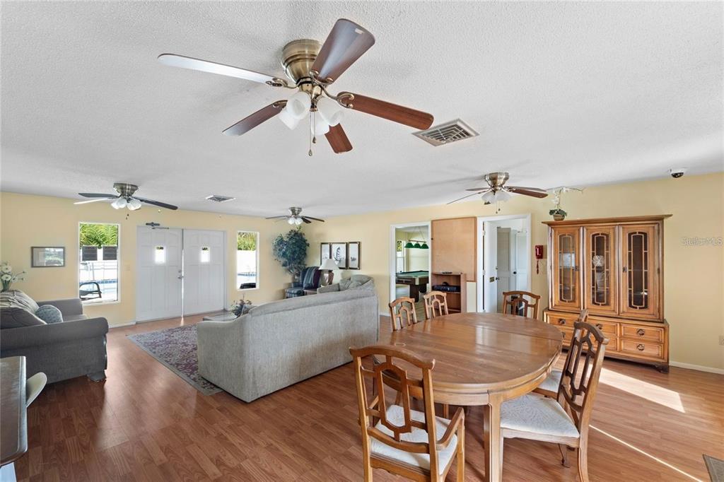 4800 Rilma Avenue, Unit 141 Sarasota, FL 34234 - Photo 18 of 19 a view of a dining room and livingroom with furniture wooden floor a chandelier