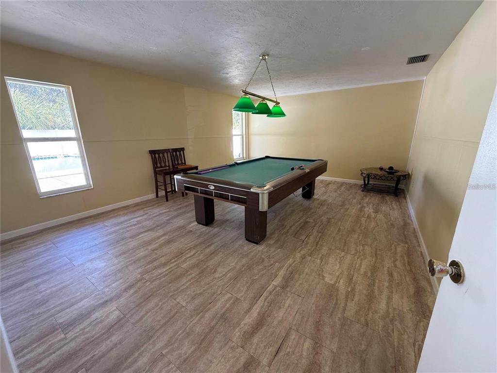 4800 Rilma Avenue, Unit 141 Sarasota, FL 34234 - Photo 19 of 19 an empty room with windows and furniture