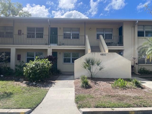 4800 Rilma Avenue, Unit 141 Sarasota, FL 34234 - Photo 2 of 19 a front view of a house with garden
