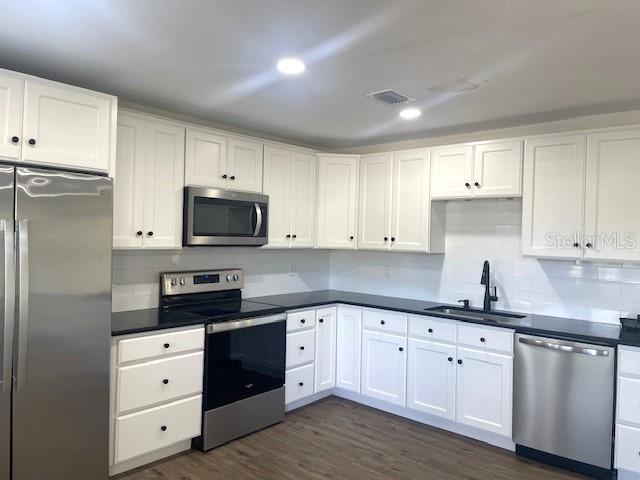 4800 Rilma Avenue, Unit 141 Sarasota, FL 34234 - Photo 5 of 19 a kitchen with white cabinets white stainless steel appliances and sink