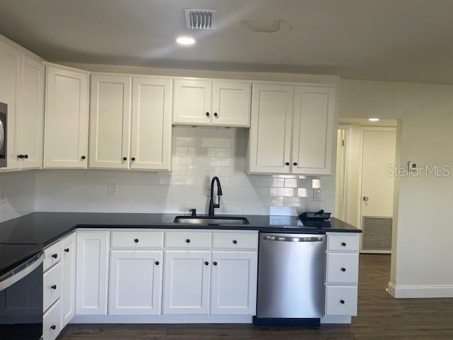 4800 Rilma Avenue, Unit 141 Sarasota, FL 34234 - Photo 6 of 19 a kitchen with granite countertop white cabinets and stainless steel appliances