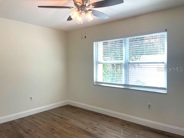 4800 Rilma Avenue, Unit 141 Sarasota, FL 34234 - Photo 9 of 19 a view of an empty room with wooden floor and a window