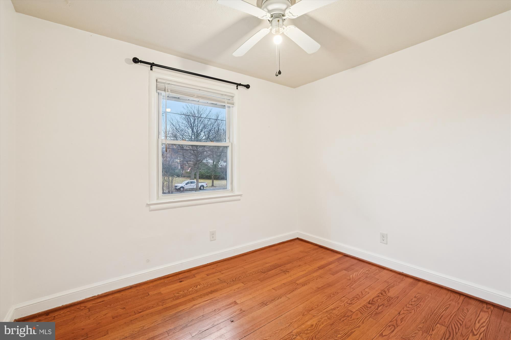 10502 Glenhaven Drive Silver Spring, MD 20902 - Photo 14 of 38 an empty room with a window and wooden floor