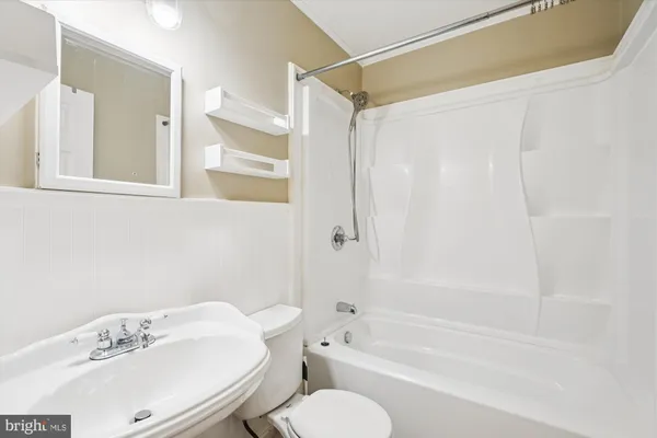a bathroom with a sink toilet and bathtub