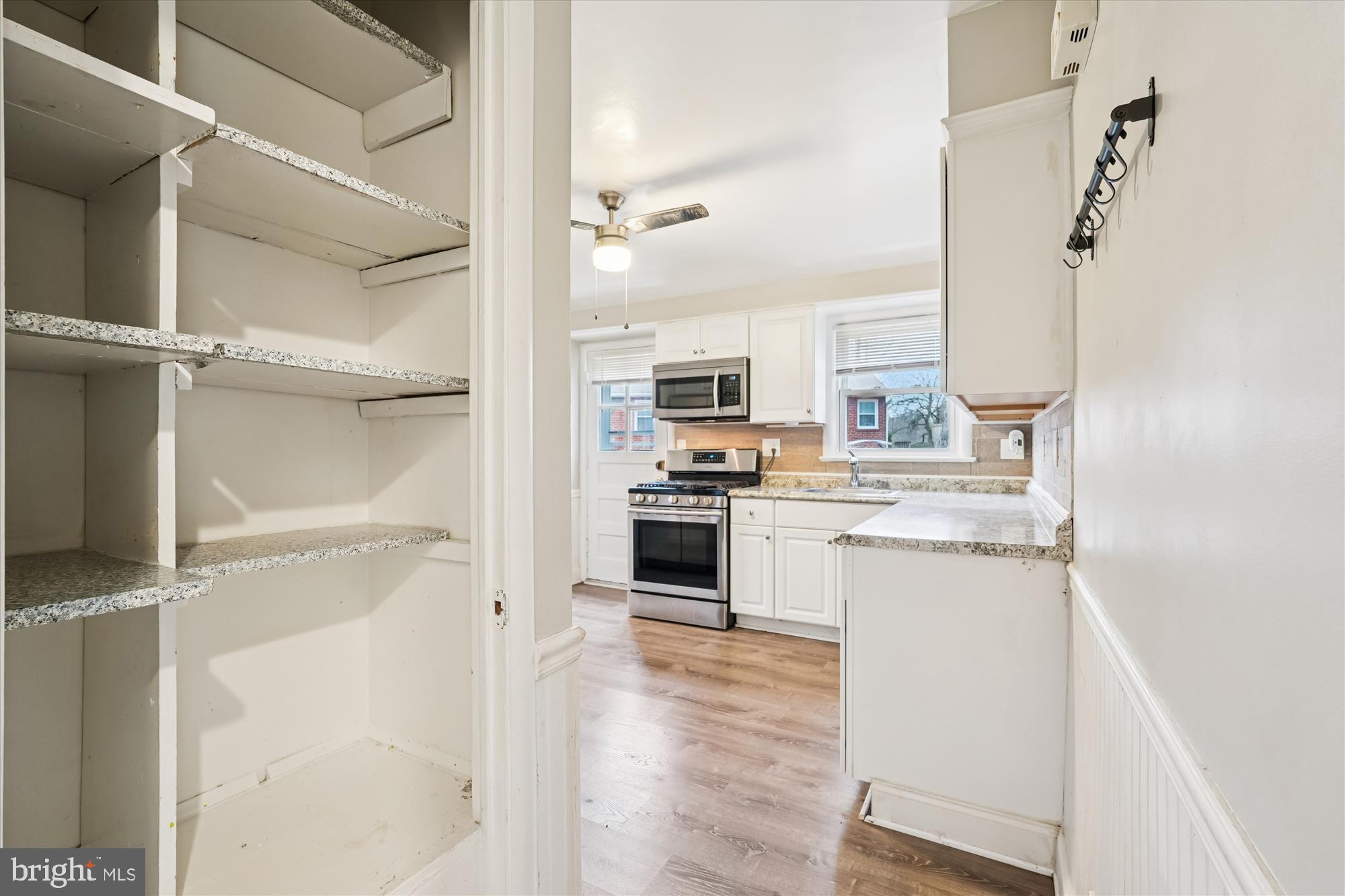 10502 Glenhaven Drive Silver Spring, MD 20902 - Photo 6 of 38 a kitchen with a refrigerator and white cabinets