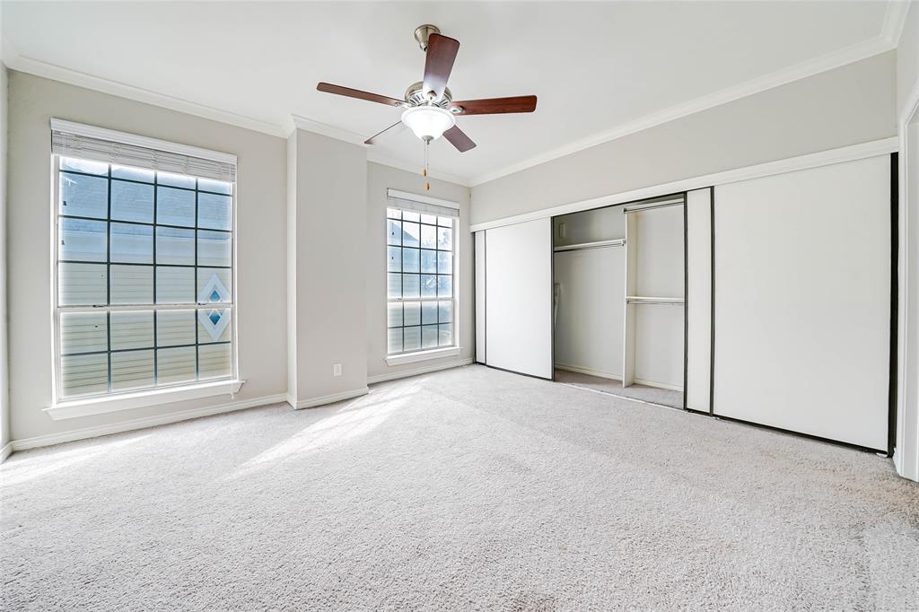 3605 Brown Street, Unit B108 Dallas, TX 75219 - Photo 11 of 18 an empty room with windows and ceiling fan