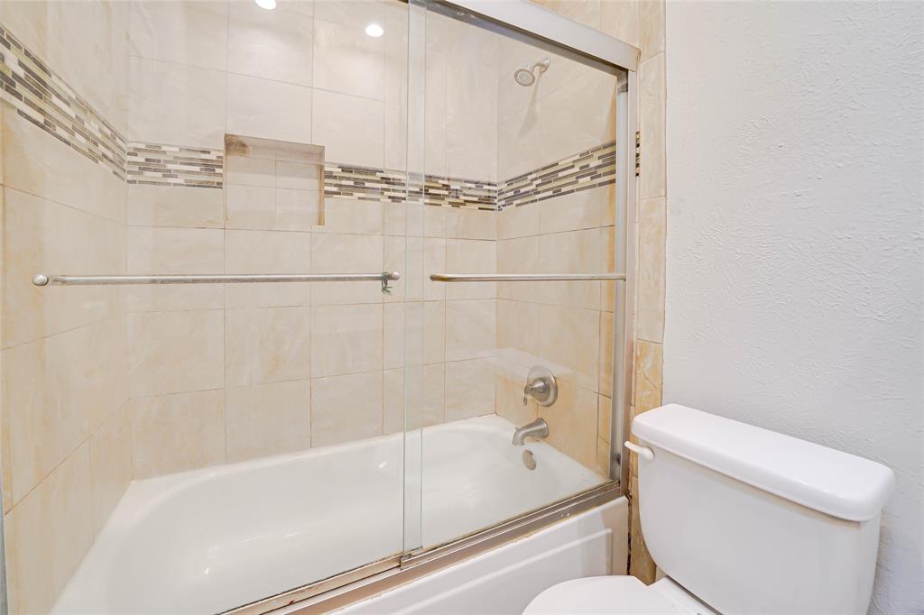 3605 Brown Street, Unit B108 Dallas, TX 75219 - Photo 13 of 18 a bathroom with a toilet and a shower