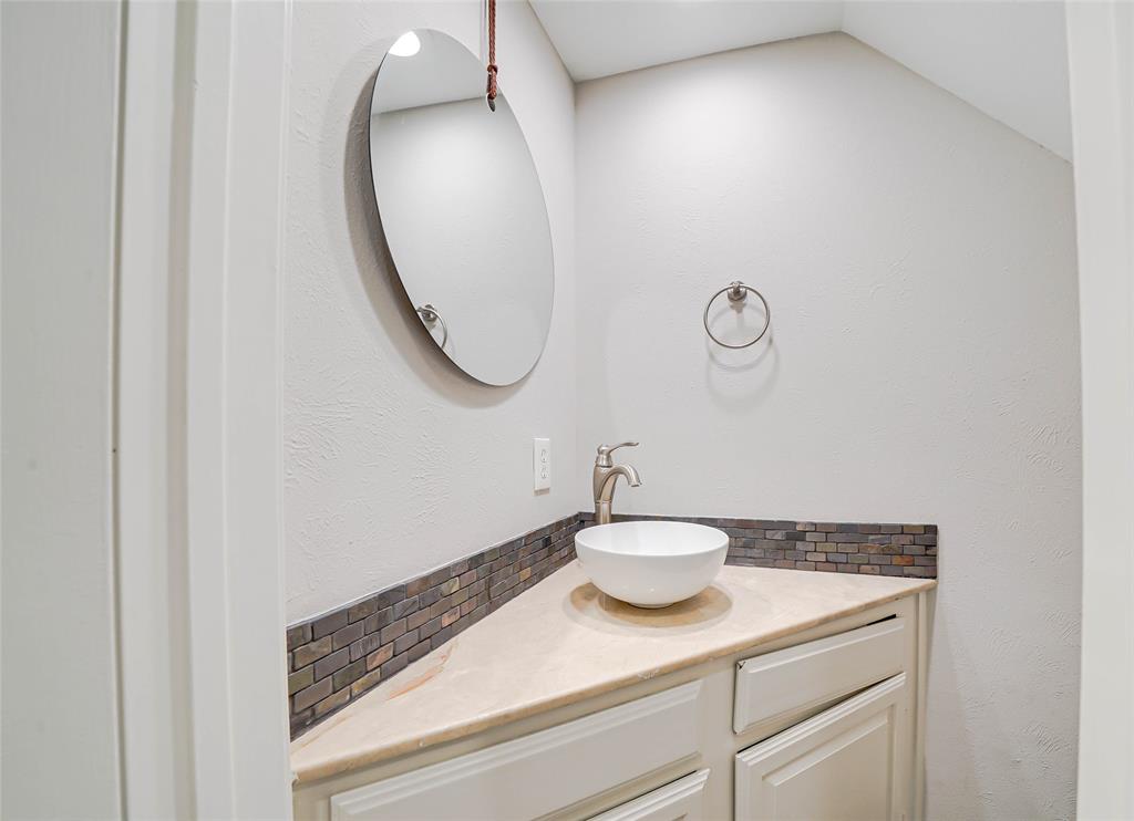3605 Brown Street, Unit B108 Dallas, TX 75219 - Photo 5 of 18 a bathroom with a sink and a mirror