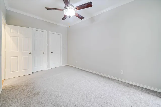 an empty room with a chandelier fan