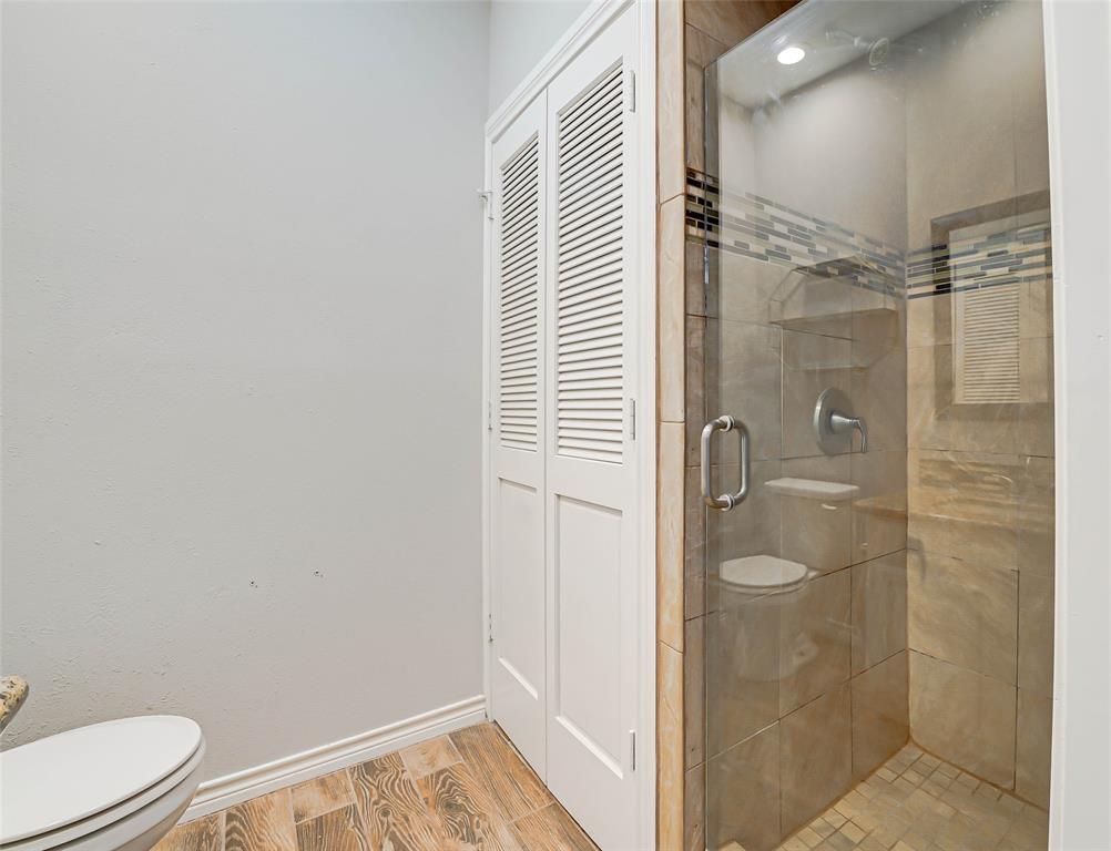 3605 Brown Street, Unit B108 Dallas, TX 75219 - Photo 10 of 18 a bathroom with a shower and a toilet