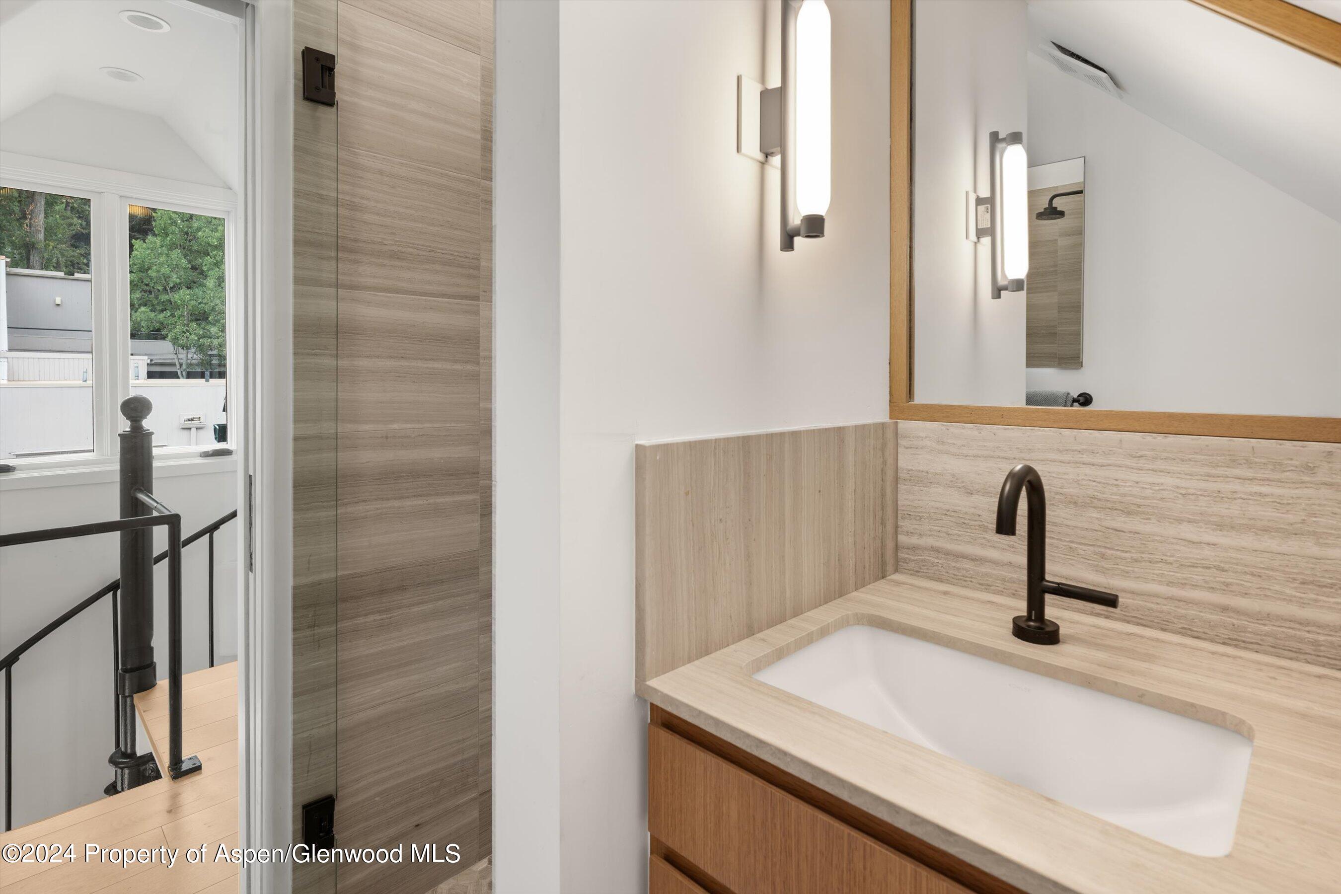 331 West Main Street, Unit B Aspen, CO 81611 - Photo 13 of 21 a bathroom with a sink and a mirror