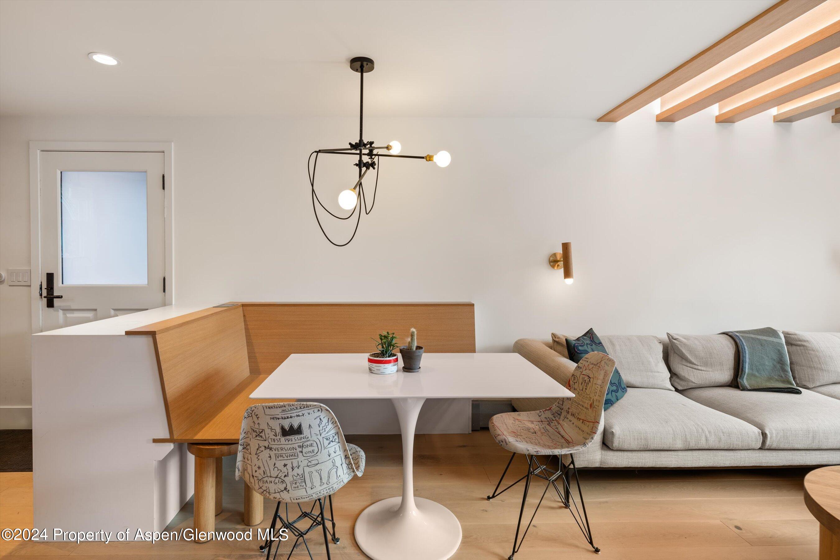 331 West Main Street, Unit B Aspen, CO 81611 - Photo 5 of 21 a view of a dining room with furniture and wooden floor