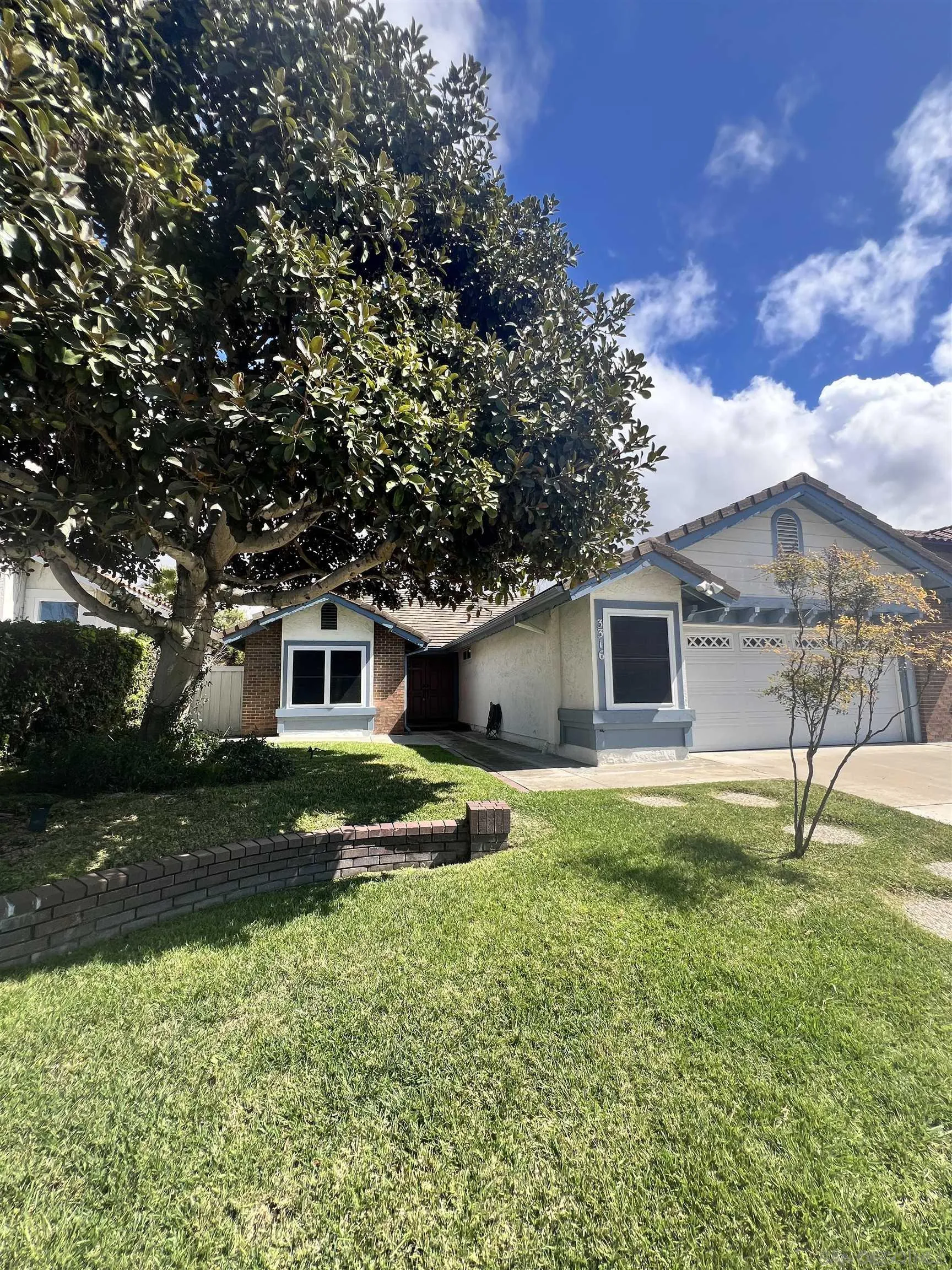 a house view with a sitting space and garden