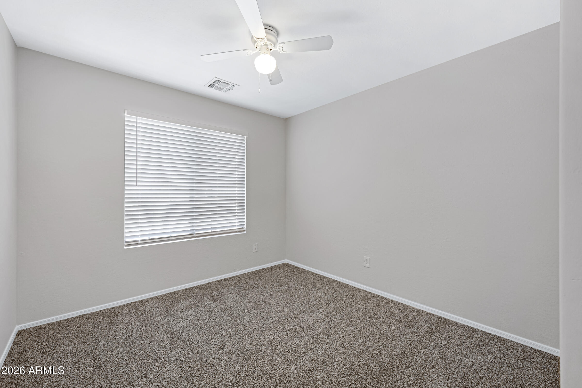 19408 North Braden Road Maricopa, AZ 85138 - Photo 26 of 51 an empty room with a window and a fan