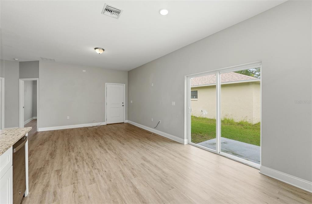 314 Colonade Court, Unit B Kissimmee, FL 34758 - Photo 12 of 24 an empty room with wooden floor and windows