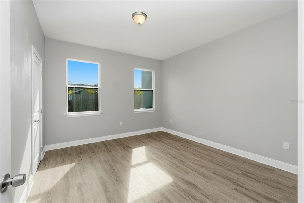 314 Colonade Court, Unit B Kissimmee, FL 34758 - Photo 13 of 24 an empty room with wooden floor and windows