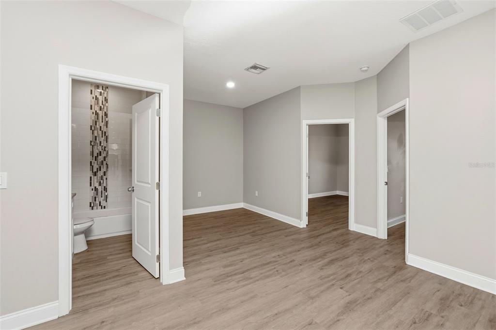 314 Colonade Court, Unit B Kissimmee, FL 34758 - Photo 6 of 24 wooden floor in an empty room with a gallery