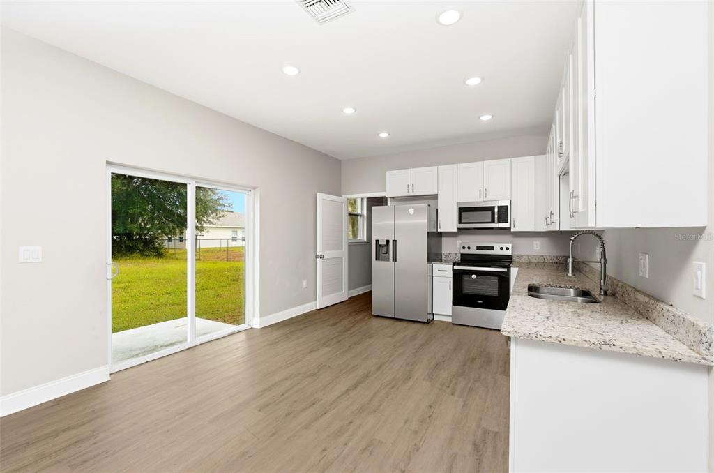314 Colonade Court, Unit B Kissimmee, FL 34758 - Photo 8 of 24 a kitchen with stainless steel appliances granite countertop a stove top oven a sink and dishwasher