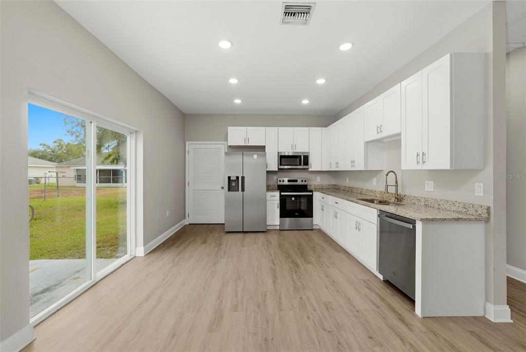 314 Colonade Court, Unit B Kissimmee, FL 34758 - Photo 9 of 24 a large kitchen with granite countertop a large counter top stainless steel appliances and cabinets