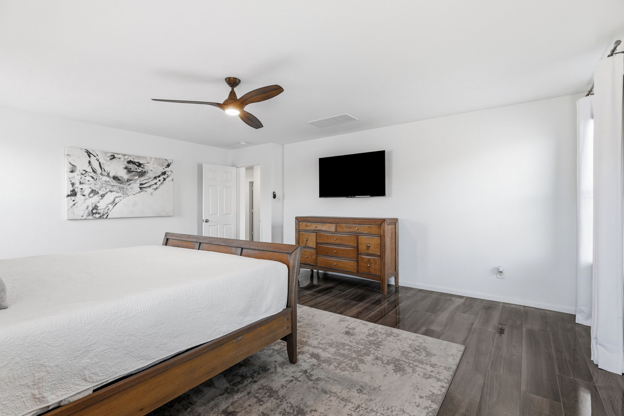 5127 Avondale Rise Street Katy, TX 77493 - Photo 24 of 47 a bedroom with a bed and a flat screen tv