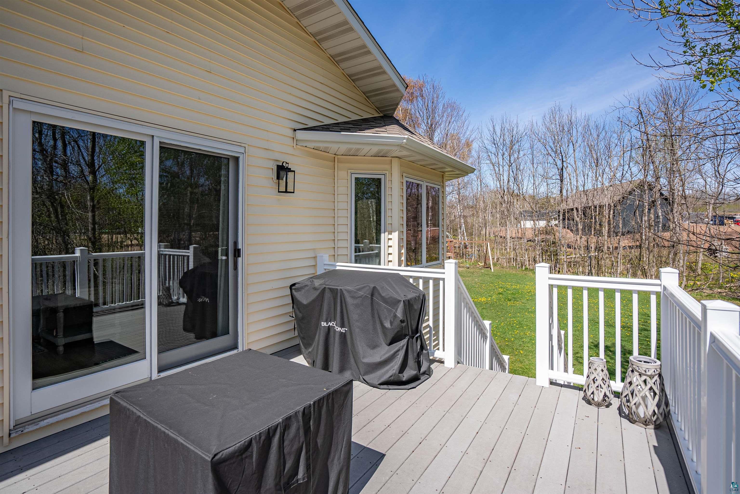 4809 Oak Ridge Drive Hermantown, MN 55811 - Photo 6 of 69 Exterior deck featuring composite decking, white railing, and a sliding glass door