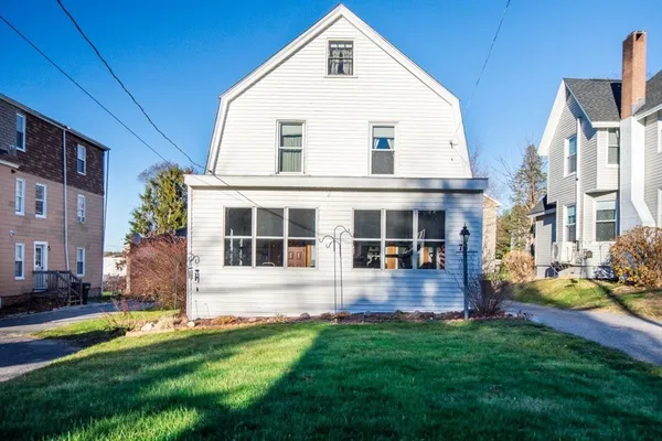 a front view of house with yard and green space
