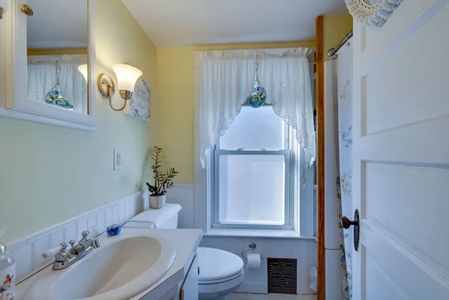 a bathroom with a sink vanity granite and a mirror
