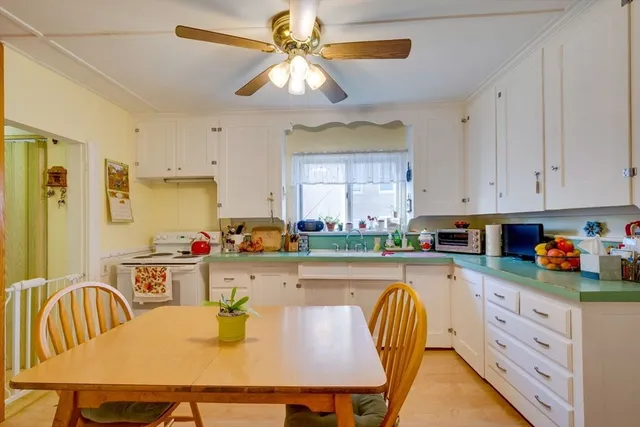 a kitchen with a table chairs and a refrigerator